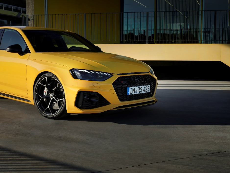 A yellow car parked in front of a building
Description automatically generated